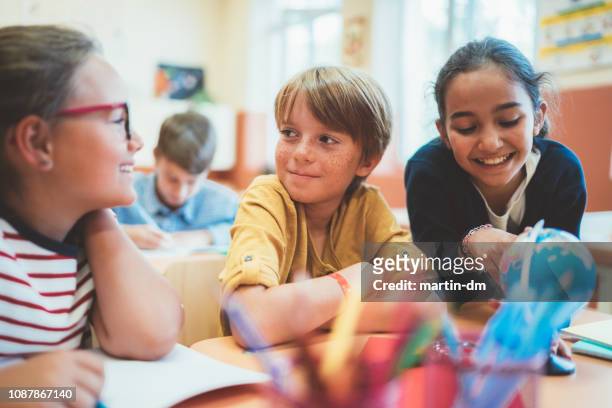 school children enjoying a geography lesson - elementary school building stock pictures, royalty-free photos & images