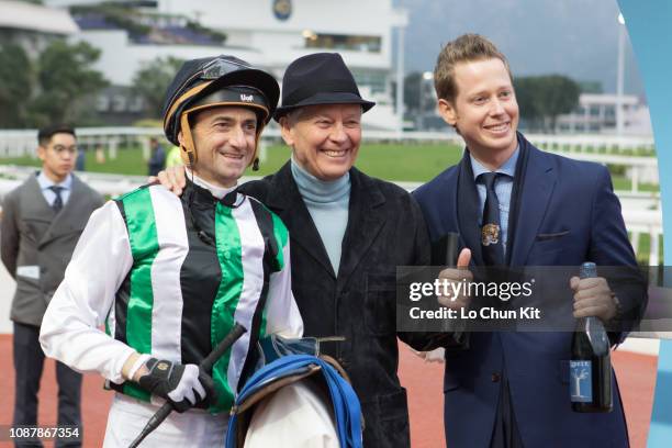 Jockey Douglas Whyte, trainer John Moore and his son George Moore celebrate after People's Knight winning Race 9 Shui Chuen O Handicap at Sha Tin...