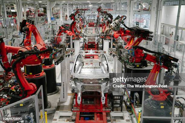 Kuka robots work on Tesla Model X in the Tesla factory in Fremont, California, on Thursday, July 26, 2018.
