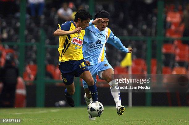Angel Reyna Of America struggles for the ball with Noe Maya of San Luis during a match as part of the Clausura 2011 Tournament in the Mexican...