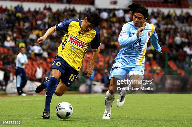 Angel Reyna of America Struggles for the ball with Noe Maya of San Luis during a match as part of the Clausura 2011 Tournament in the Mexican...