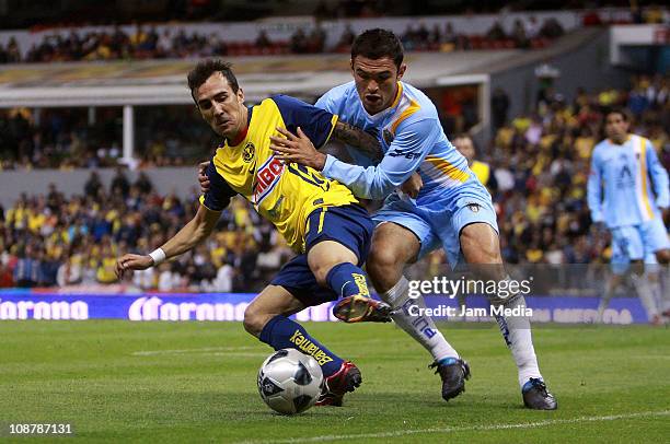 Vicente Sanchez of America struggles for the ball with Luis Omar Hernandez of San Luis during a match as part of the Clausura 2011 Tournament in the...