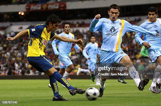 Angel Reyna of America struggles for the ball with Christian Sanchez of San Luis during a match as part of the Clausura 2011 Tournament in the...
