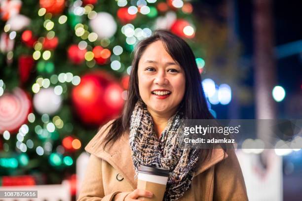 asian couple christmas shopping at night - hot filipina women stock pictures, royalty-free photos & images