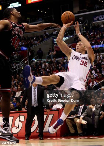 Blake Griffin of the Los Angeles Clippers gets off a shot as he falls after being fouled by Kurt Thomas of the Chicago Bulls at Staples Center on...