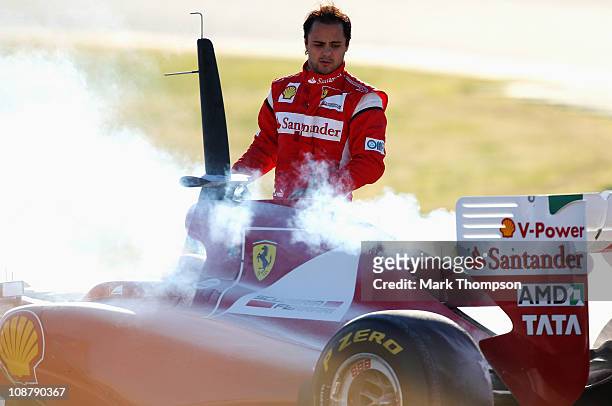 Felipe Massa of Brazil and Ferrari looks at his car following an engine problem during day three of winter testing at the Ricardo Tormo Circuit on...