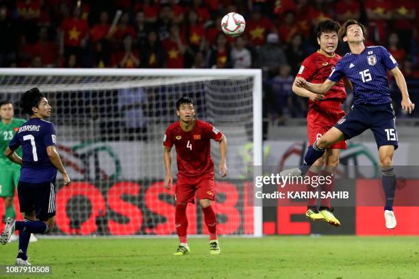 Japan's forward Yuya Osako vies for the header with Vietnam's midfielder Xuan Truong Luong during the 2019 AFC Asian Cup quarter-final football match...