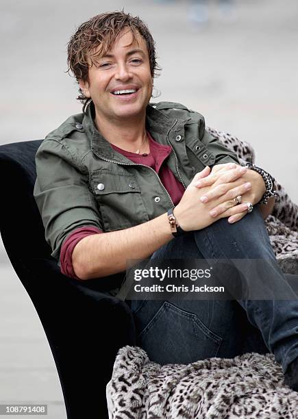 Designer Julian Macdonald poses at the launch of his new DIAMOND Debenhams Collection outside Debenhams on Oxford Street on February 3, 2011 in...