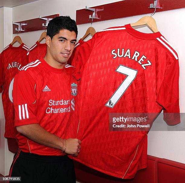 New signing Luis Suarez of Liverpool poses with his shirt at Anfield on February 3, 2011 in Liverpool, England.