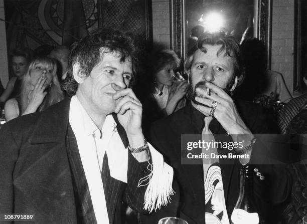 Guitarist Keith Richards of the Rolling Stones, and former Beatles drummer Ringo Starr attend Julia Carling's birthday party at Crazy Larry's, circa...