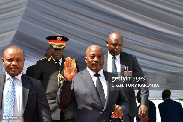 Democratic Republic of the Congo's outgoing President Joseph Kabila waves as he walks off the podium on January 24, 2019 after he officially handed...
