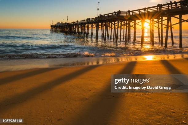 sunset behind the pier 1 - newport beach stock-fotos und bilder