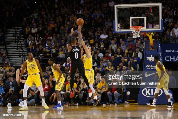 Damian Lillard of the Portland Trail Blazers shoots over Stephen Curry of the Golden State Warriors at ORACLE Arena on December 27, 2018 in Oakland,...