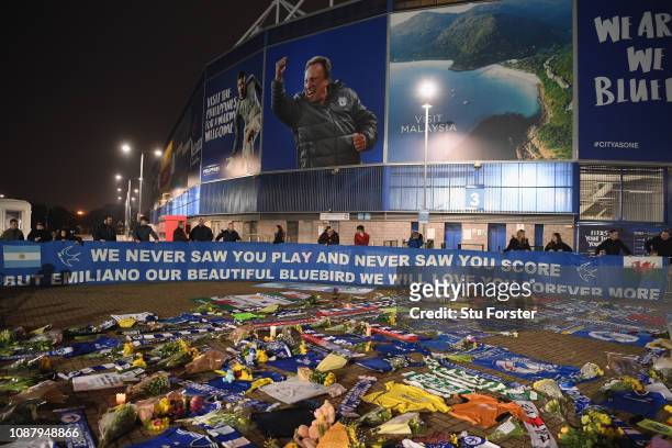 Cardiff City fans unveil a flag in front of tributes for their £15 Million forward Emiliano Sala after the search for the missing Footballer and...