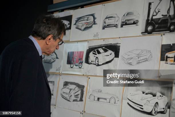 Man observing Marcello Gandini's drawings during the exhibition dedicated to Marcello Gandini the hidden genius at the Museo Nazionale...