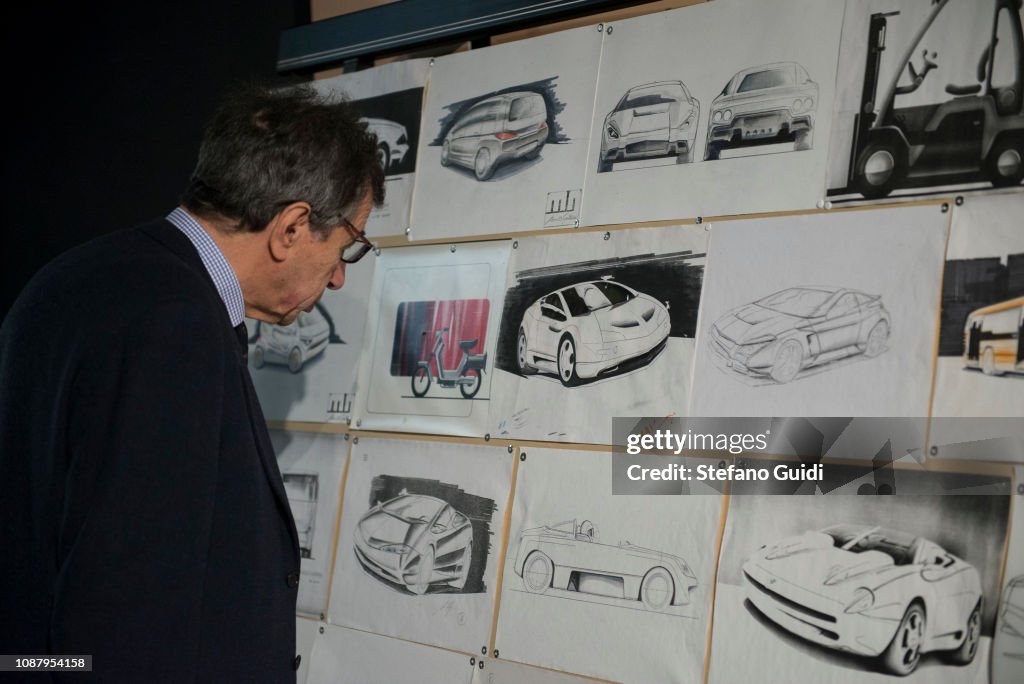 A man observing Marcello Gandini's drawings during the...
