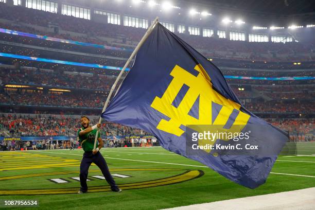 Notre Dame Fighting Irish cheerleader waves a flag during the College Football Playoff Semifinal Goodyear Cotton Bowl Classic against the Clemson...