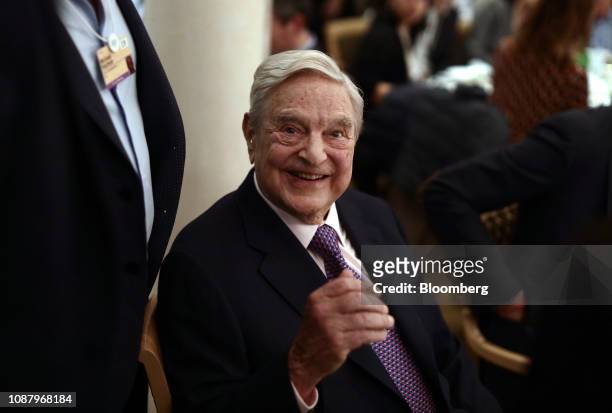 George Soros, billionaire and founder of Soros Fund Management LLC, smiles before speaking at an event on day three of the World Economic Forum in...