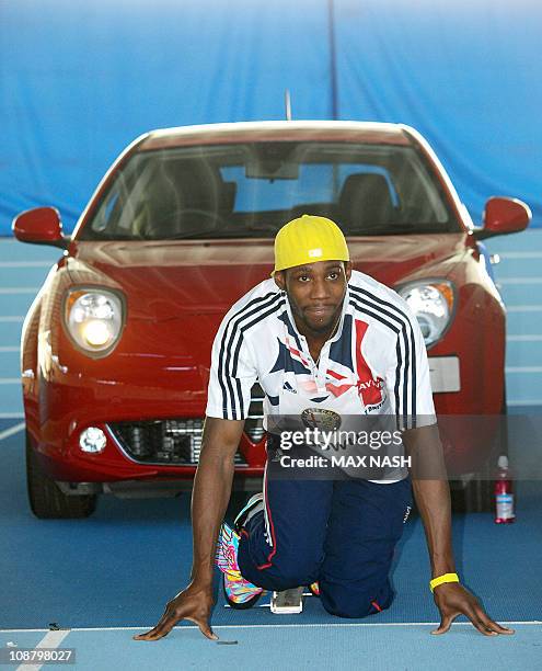 British triple jump champion Philips Idowu practises in the blocks as he poses for photographers during the launch of the new Alfa Romeo MiTo Sprint...
