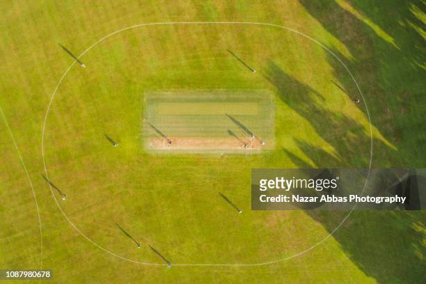 aerial view of cricket game. - cricket field stock pictures, royalty-free photos & images
