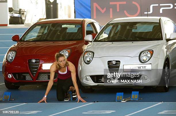 British heptathlon specialist Louise Wood practises in the blocks as she poses for photographers during the launch of the new Alfa Romeo MiTo Sprint...