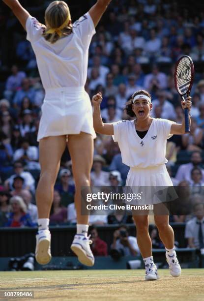 Jana Novotna jumps in the air to celebrate with Arantxa Sanchez Vicario after their Women's Doubles final match victory against Gigi Fernandez and...