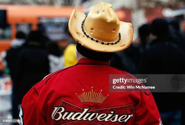 Fort Worth resident Ronnie Fountain wears a Green Bay Packers "cheesehead" cowboy hat while touring Sundance Square with other fans February 3, 2011...