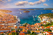 Amazing historic town of Hvar aerial view, Dalmatia, Croatia. Island of Hvar bay aerial view, Dalmatia, Croatia. Harbor of old Adriatic island town Hvar. Popular touristic destination of Croatia.