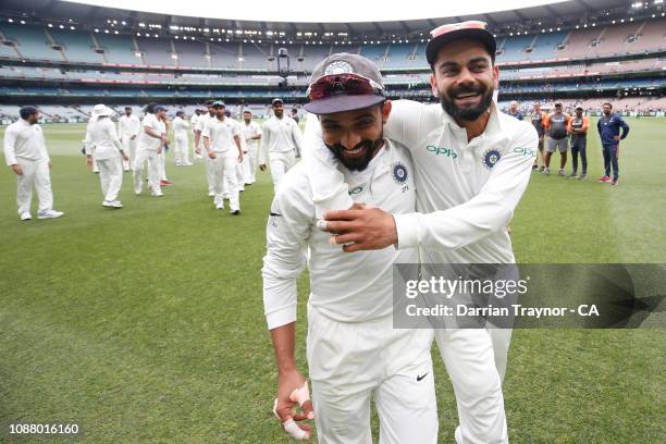 Ajinkya Rahane and Virat Kohli of India celebrate on day five of the Third Test match in the series between Australia and India at Melbourne Cricket...