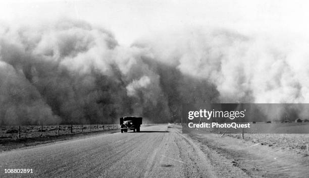 South of Lamar, Colorado, a large dust cloud appears behind a truck traveling on highway 59, May 1936.