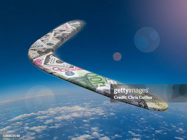 international currency boomerang above the earth - boomerang fotografías e imágenes de stock