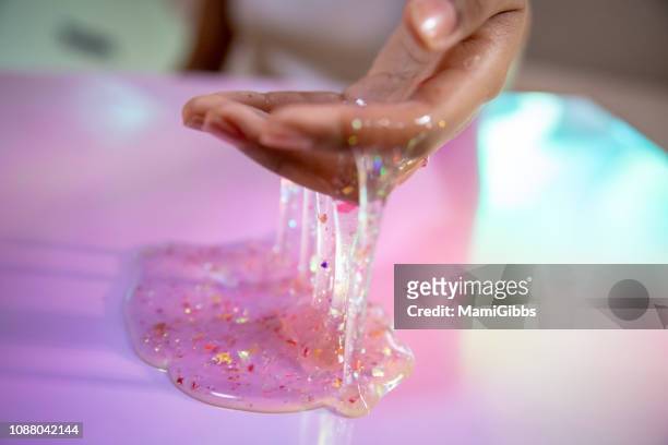 glitter slime on the hand - young thick girls stock-fotos und bilder