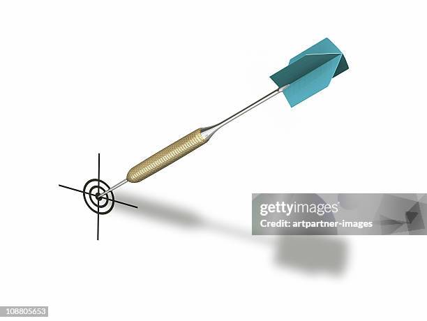 green dart hitting bulls eye on a dartboard - dart stock pictures, royalty-free photos & images