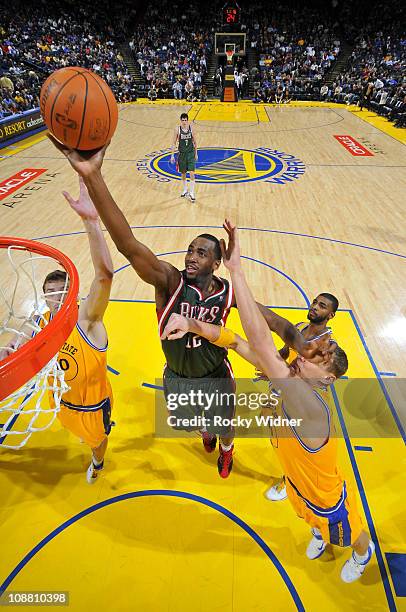 Luc Mbah A Moute of the Milwaukee Bucks attempts to lay the ball up against Andris Biedrins and David Lee of the Golden State Warriors on February 3,...