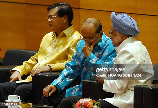 Lao Prime Minister Bouasone Buphavanh , India's Prime Minister Manmohan Singh and Myanmar's Prime Minister Thein Sein drink tea as they wait for the...