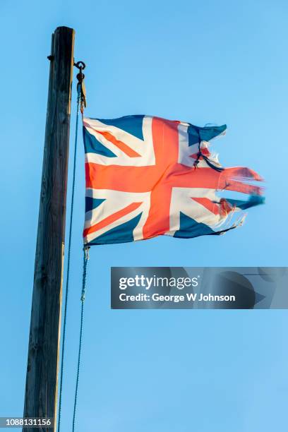 tattered union jack - old uk flag stock-fotos und bilder