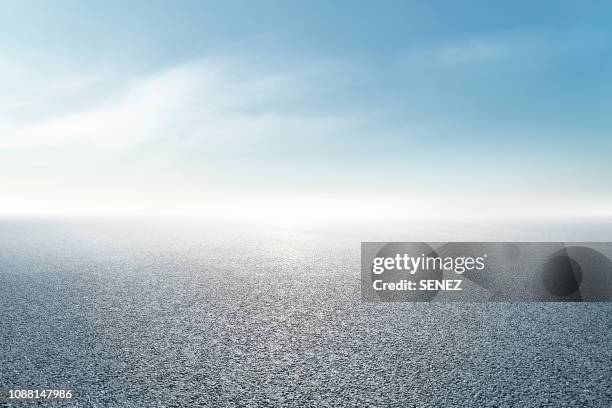 empty parking lot - sparse clouds stock pictures, royalty-free photos & images