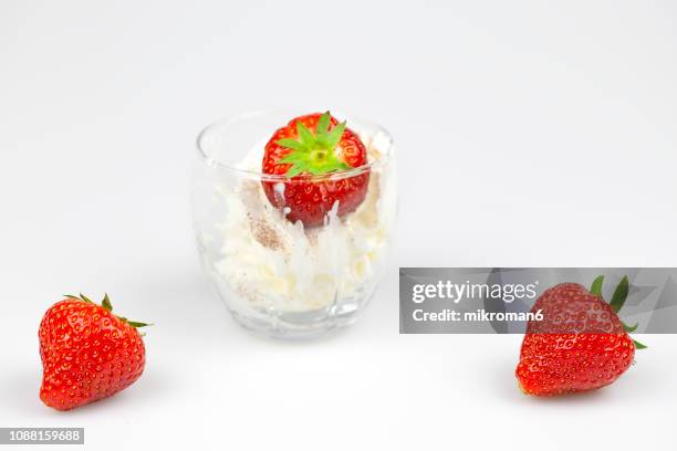 strawberry with whipped cream - strawberry and cream stock pictures, royalty-free photos & images