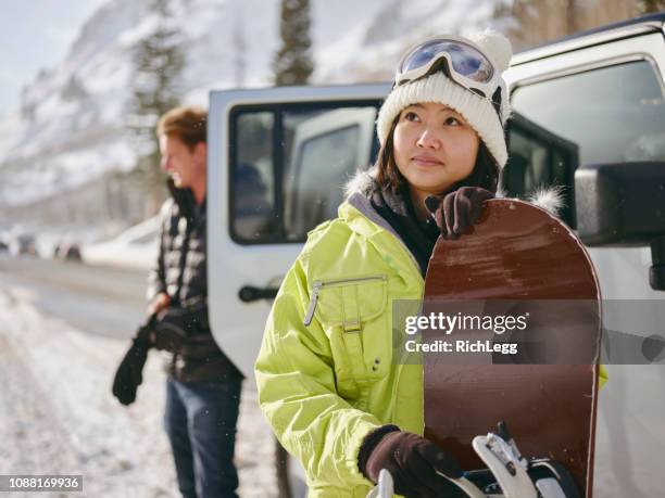 young adults enjoying a winter outing - woman skiing stock pictures, royalty-free photos & images