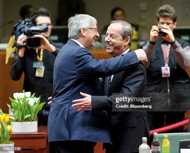 Jean-Claude Juncker, Luxembourg's prime minister, left, greets Lawrence Gonzi, Malta's prime minister, during the European Union Summit at the...