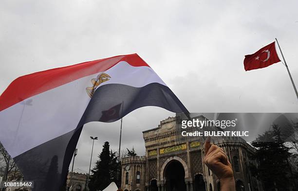 Demonstrator waves a flag of Egypt during a protest against Egypt's President Hosni Mubarak following Friday prayers at the Beyazit square in...