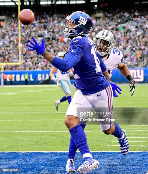Cody Latimer of the New York Giants makes a second quarter touchdown reception while defended by Byron Jones of the Dallas Cowboys at MetLife Stadium...