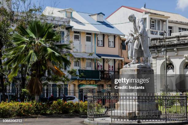 in fort de france, on the old courthouse grounds, statue of victor schoelcher. the place is now open to the public, no entrance fee, where residents and tourists can wander around, being inside and outside. - fort de france stock pictures, royalty-free photos & images