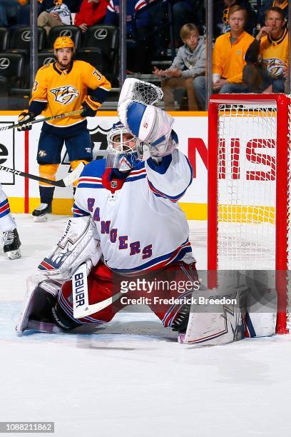 Henrik Lundqvist of the New York Rangers makes a save against the Nashville Predators during the first period at Bridgestone Arena on December 29,...