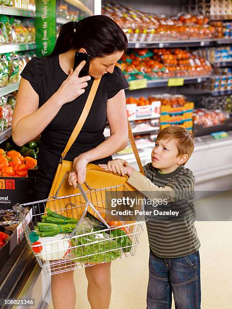 business woman shopping with unhappy son - child crying store stock pictures, royalty-free photos & images
