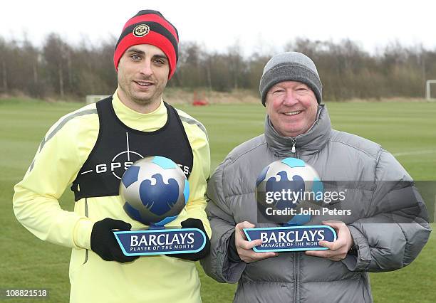 Dimitar Berbatov and Sir Alex Ferguson of Manchester United pose with the Barclays Player of the Month and Barclays Manager of the Month for January...