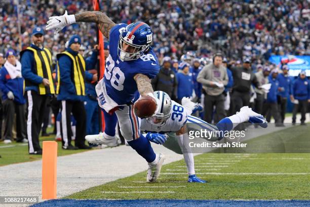 Evan Engram of the New York Giants dives into the end zone for a touchdown during the third quarter of the game against the Dallas Cowboys at MetLife...