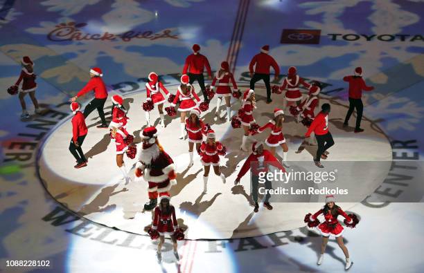 Members of the Philadelphia Flyers ice girls perform during a pregame holiday light show prior to the start of an NHL game between the Philadelphia...