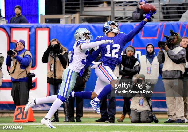 Cody Latimer of the New York Giants makes a first down reception under pressure from Anthony Brown of the Dallas Cowboys during the fourth quarter at...