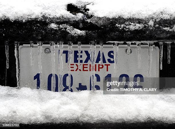 Snow covered police car sits outside the NFL football Super Bowl XLV Media Center in Dallas, Texas, on February 4, 2011. A winter storm hit Dallas...